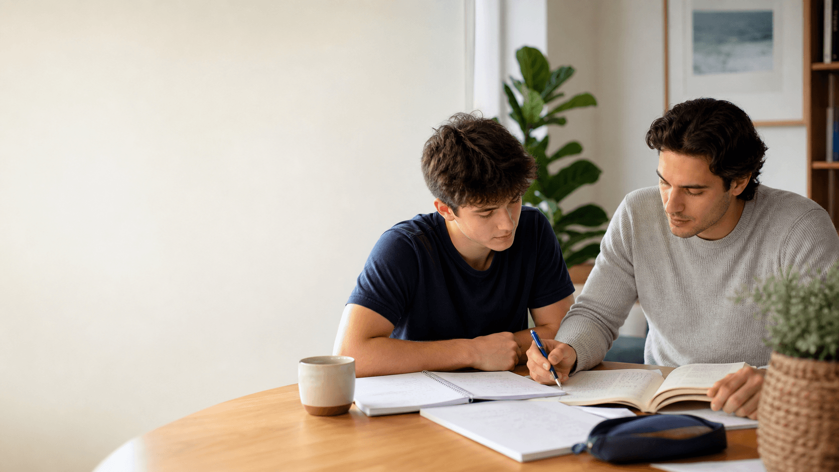 A tutor and high school student working through maths notes together.